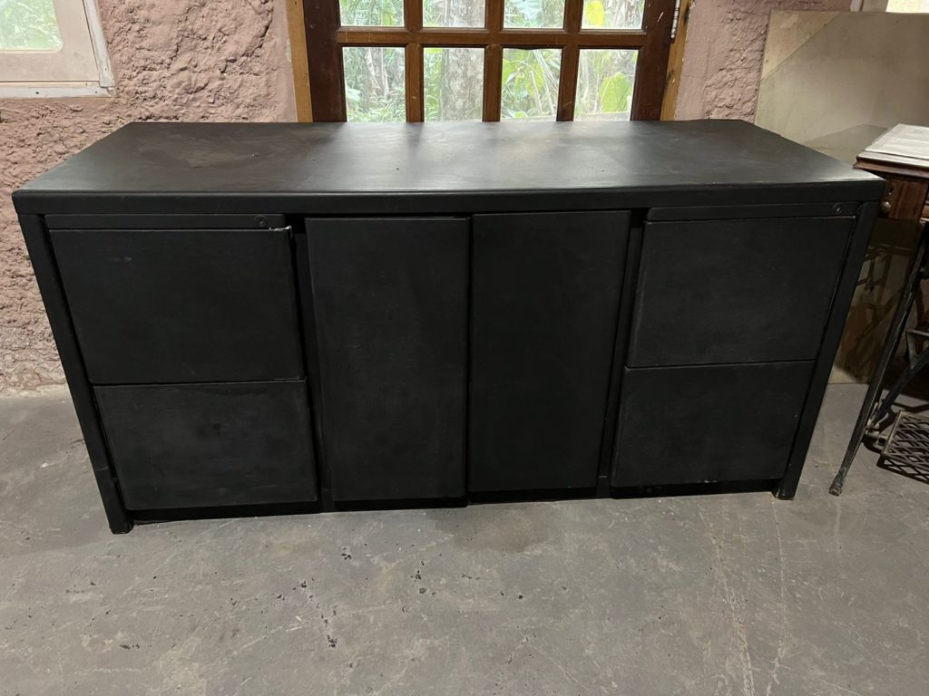Aparador pintado de preto com 2 portas e 4 gavetas.